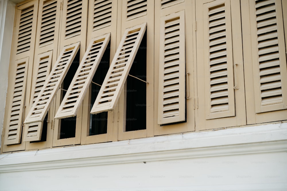a close up of a window with closed shutters
