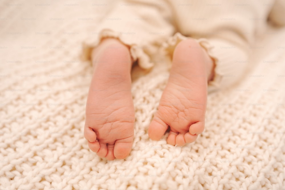 a close up of a baby's feet on a blanket