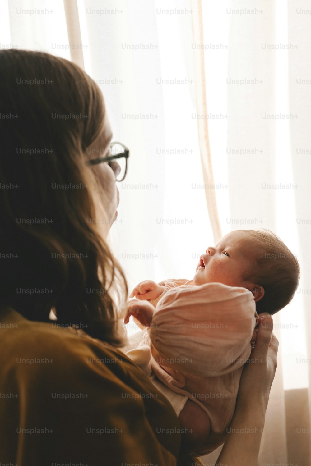 a woman holding a baby in her arms