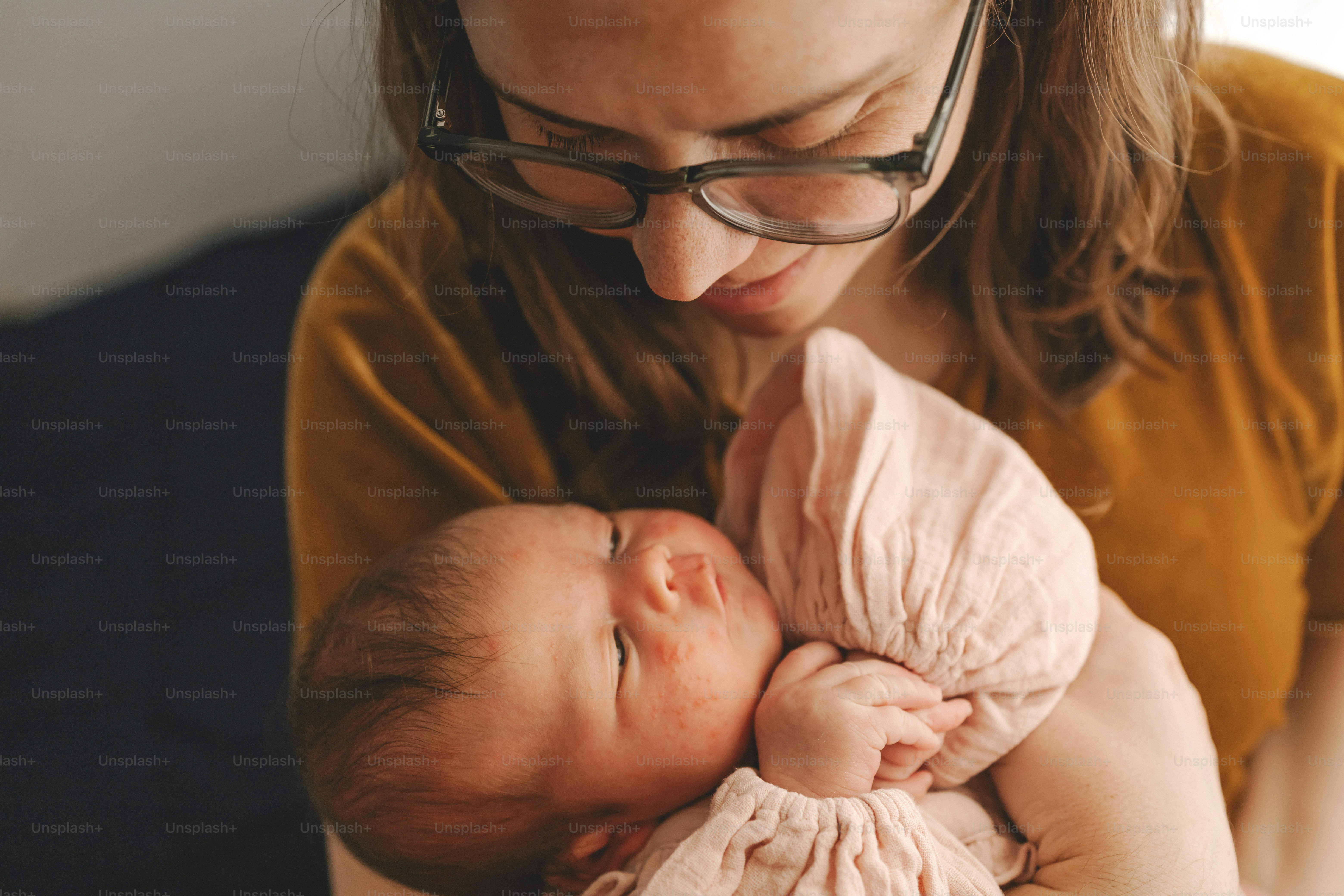 a woman holding a baby in her arms