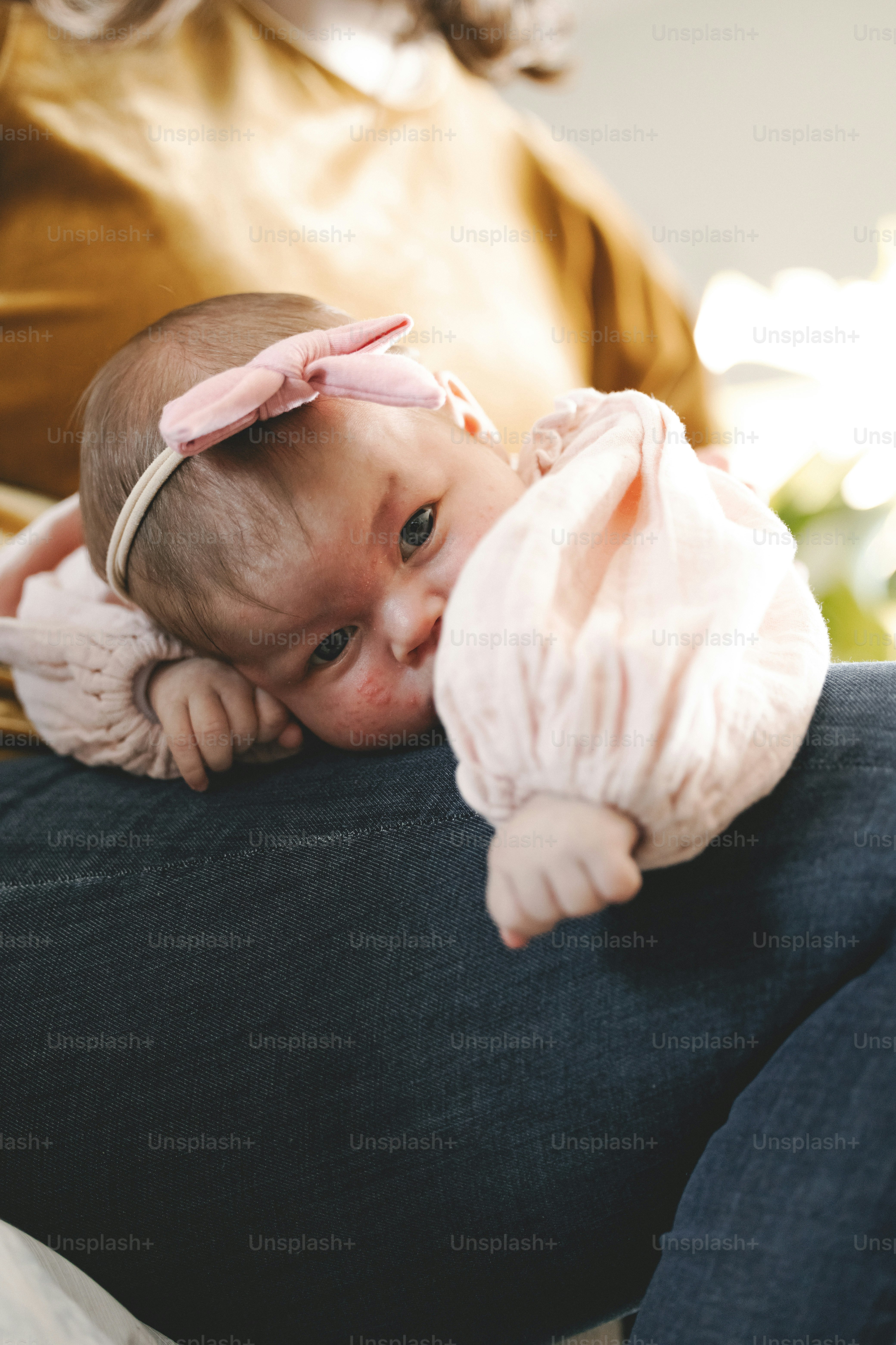 a woman holding a baby in her lap