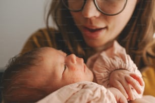 a close up of a person holding a baby