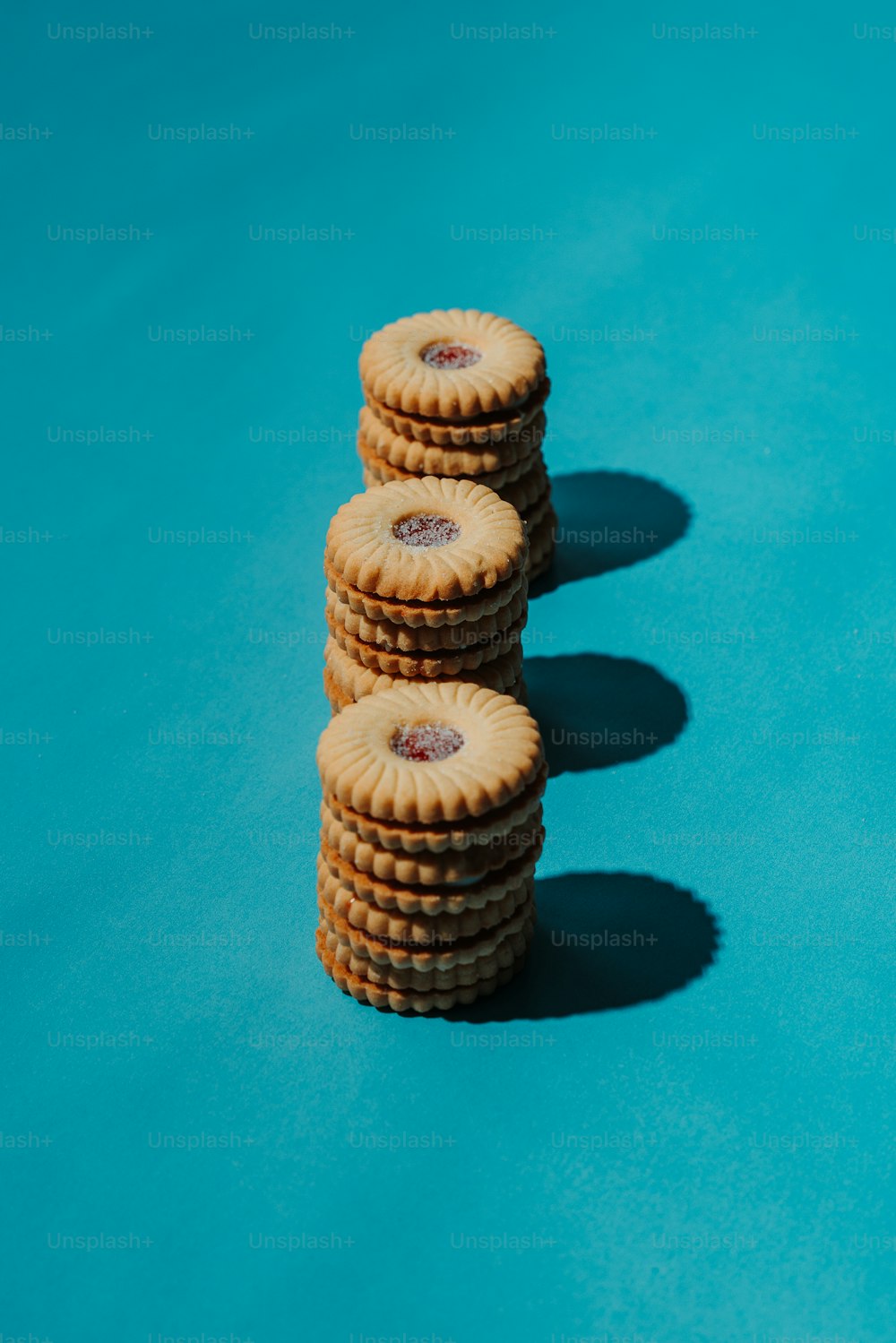a stack of cookies sitting on top of a blue surface