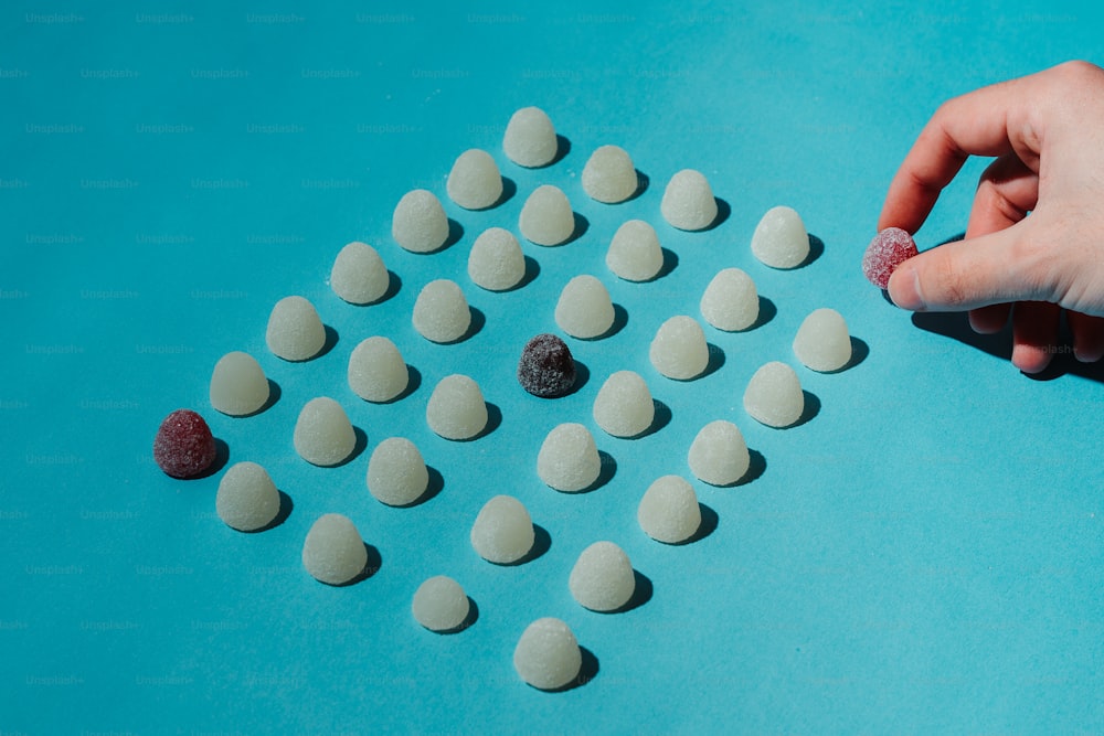 a person is making a pattern out of pills