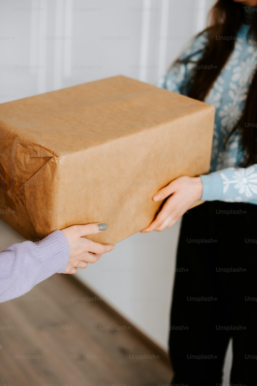 a woman holding a brown box with a brown handle