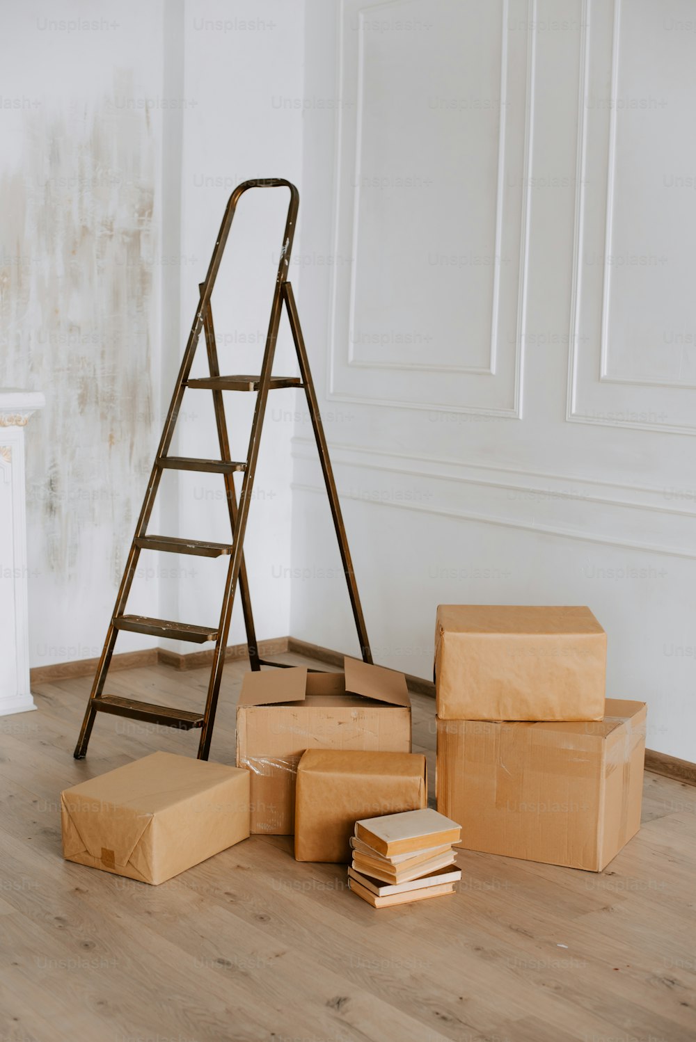 a ladder leaning against a wall next to boxes
