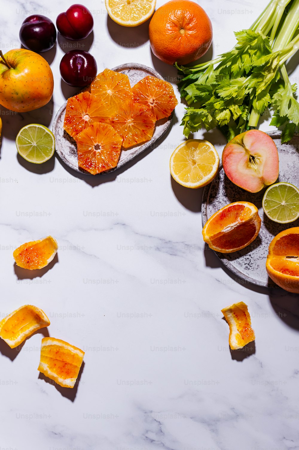 a marble table topped with fruits and vegetables