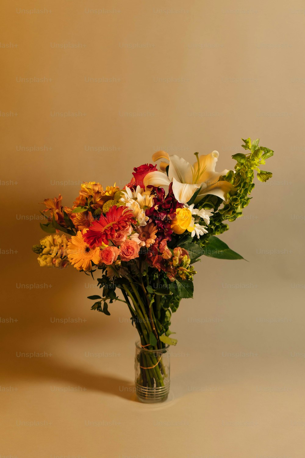 a vase filled with lots of different colored flowers