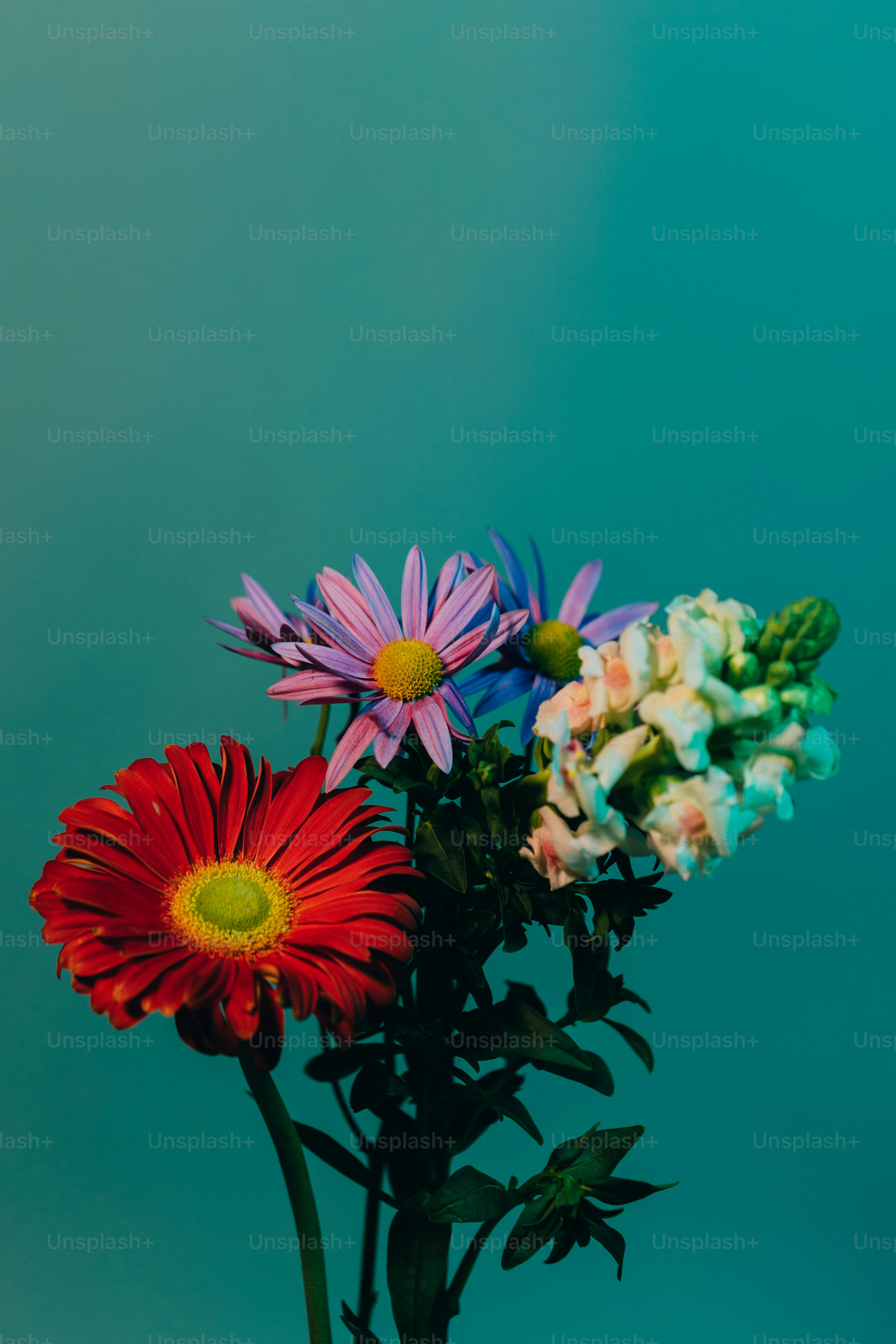 a vase filled with colorful flowers on top of a table