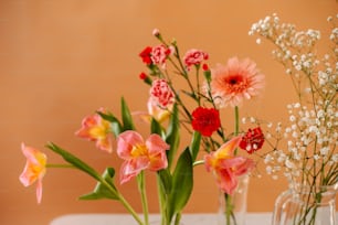 a group of vases filled with different types of flowers