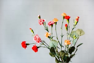 a vase filled with red and yellow flowers