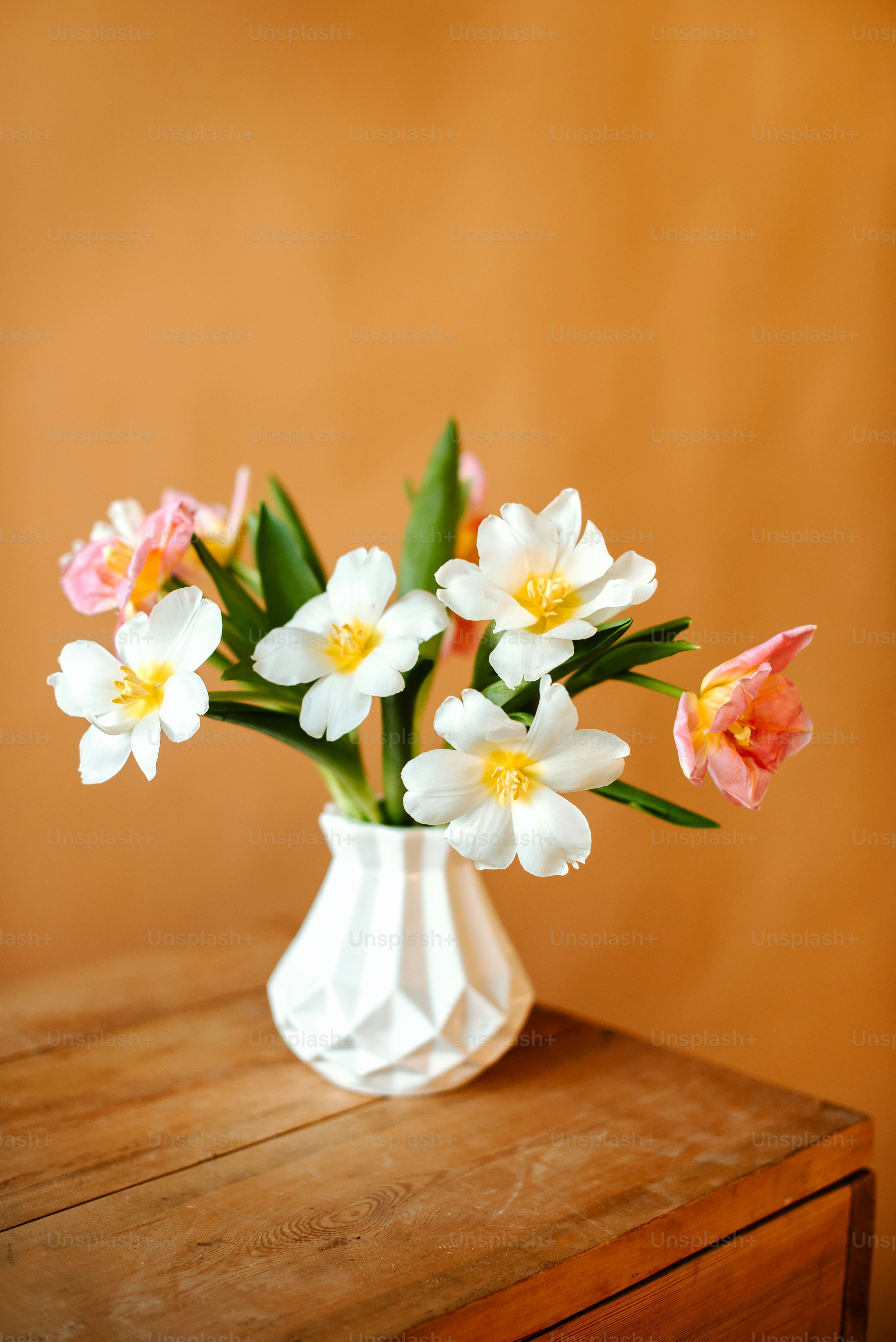 A vase filled with flowers on top of a table photo – Wallpaper Image on ...
