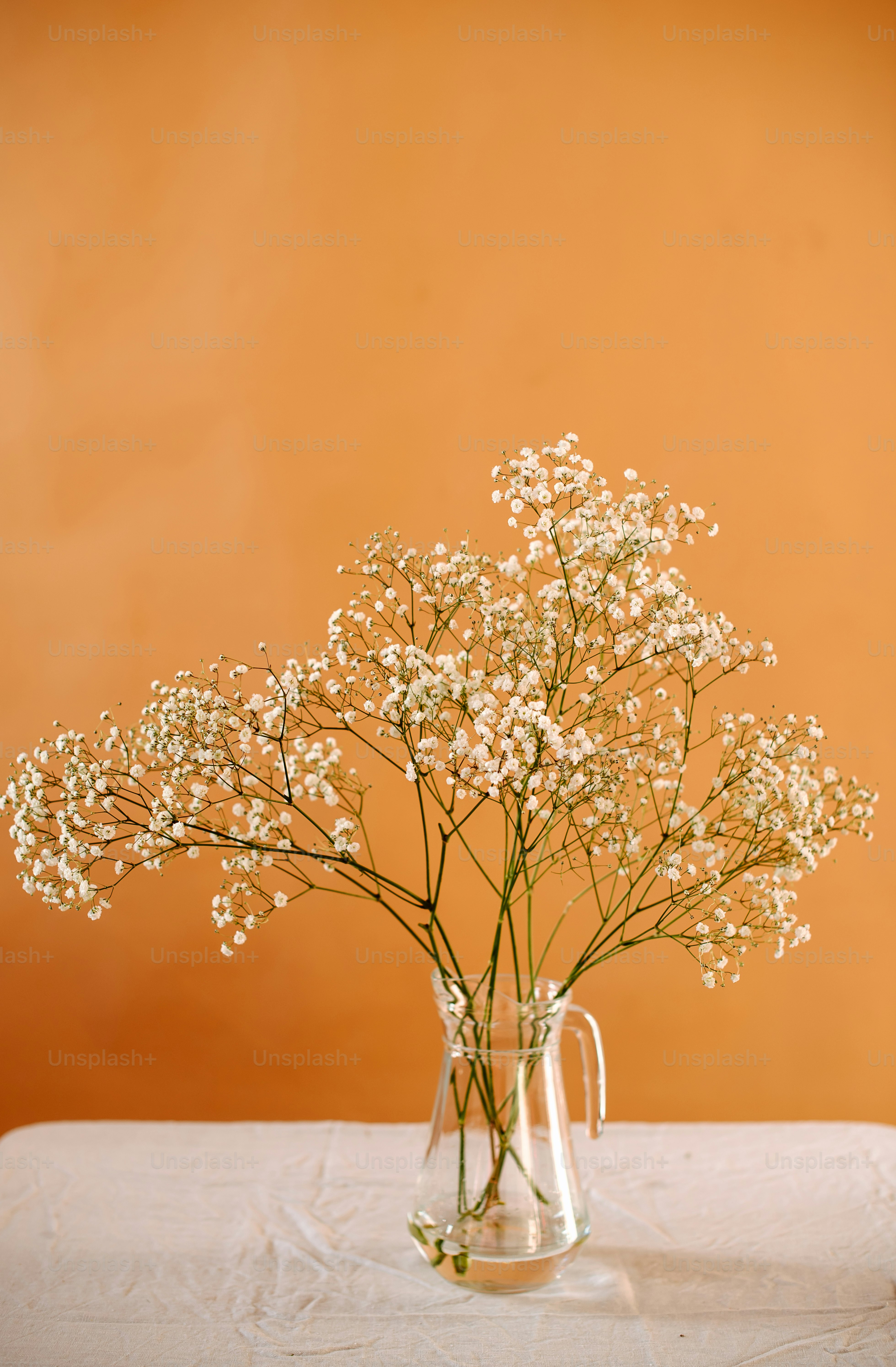 a vase filled with white flowers on top of a table