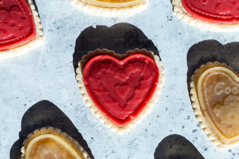 a close up of heart shaped cookies on a cookie sheet