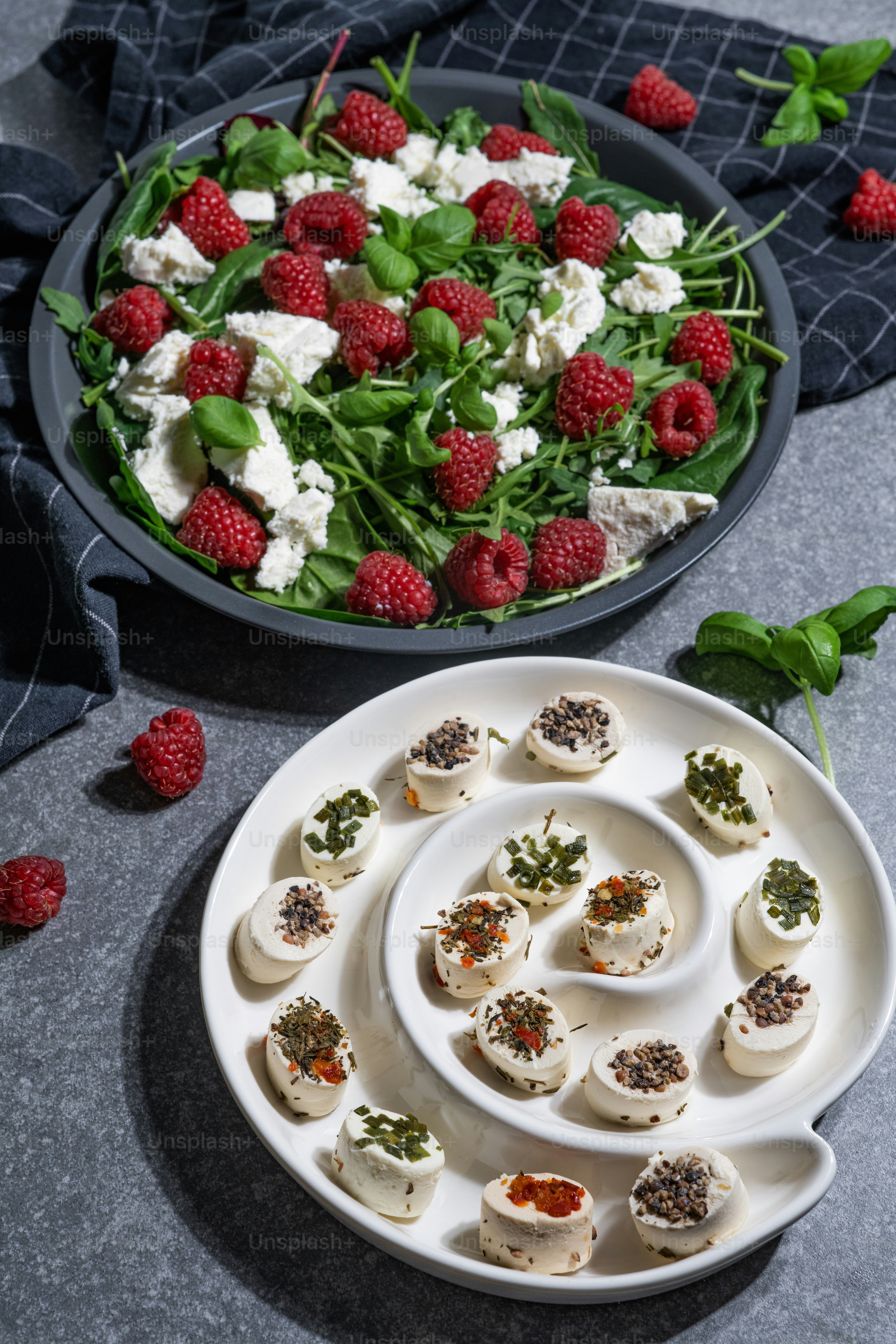 a plate of appetizers and a bowl of salad