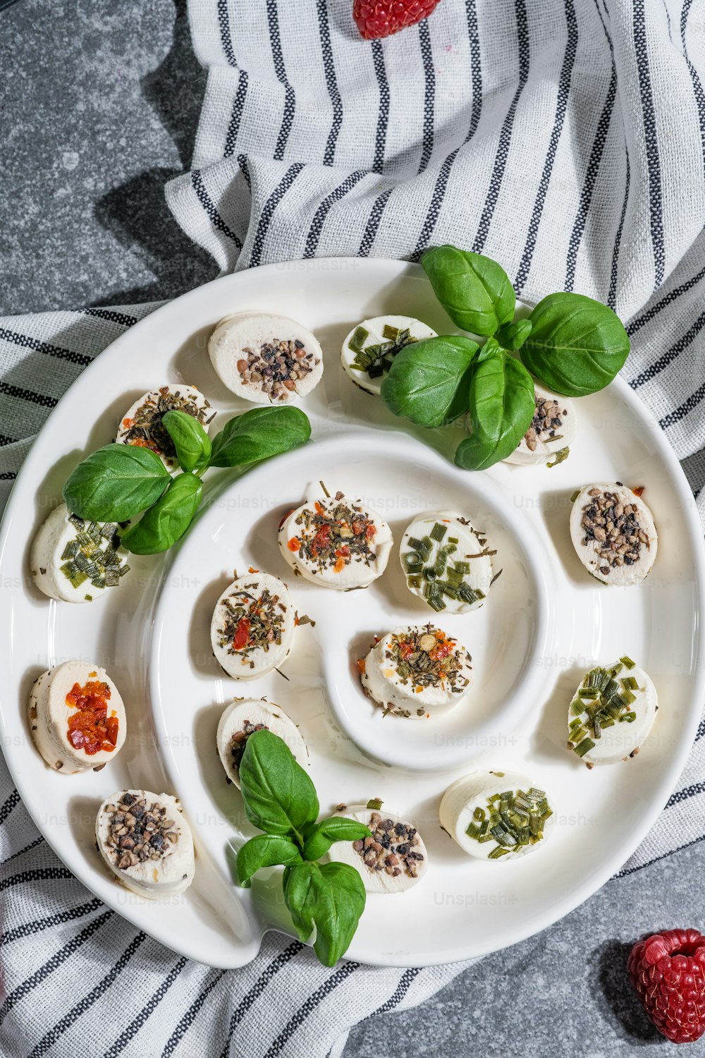 a white plate topped with deviled eggs covered in pesto