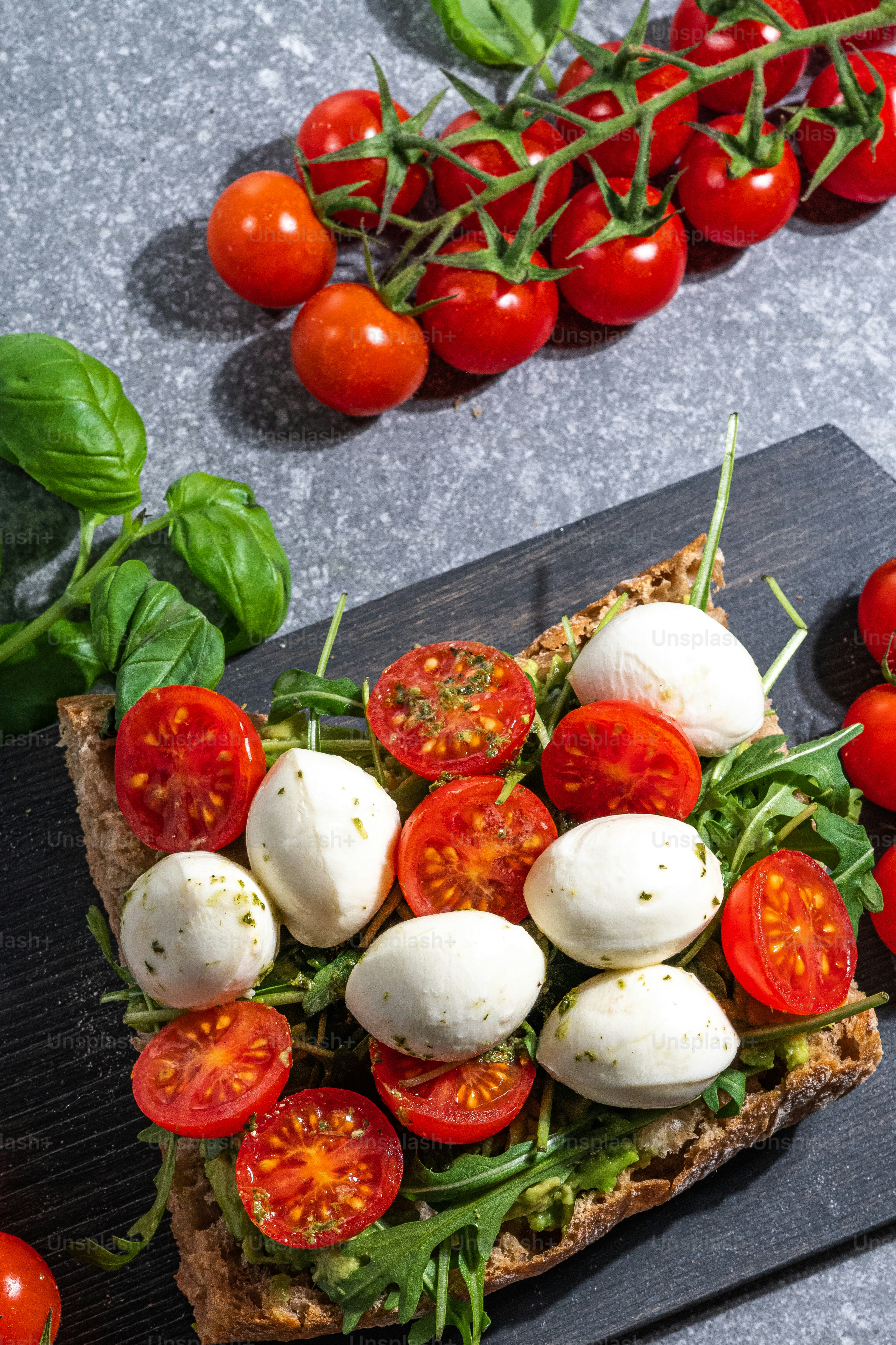 a piece of bread topped with mozzarella and tomatoes