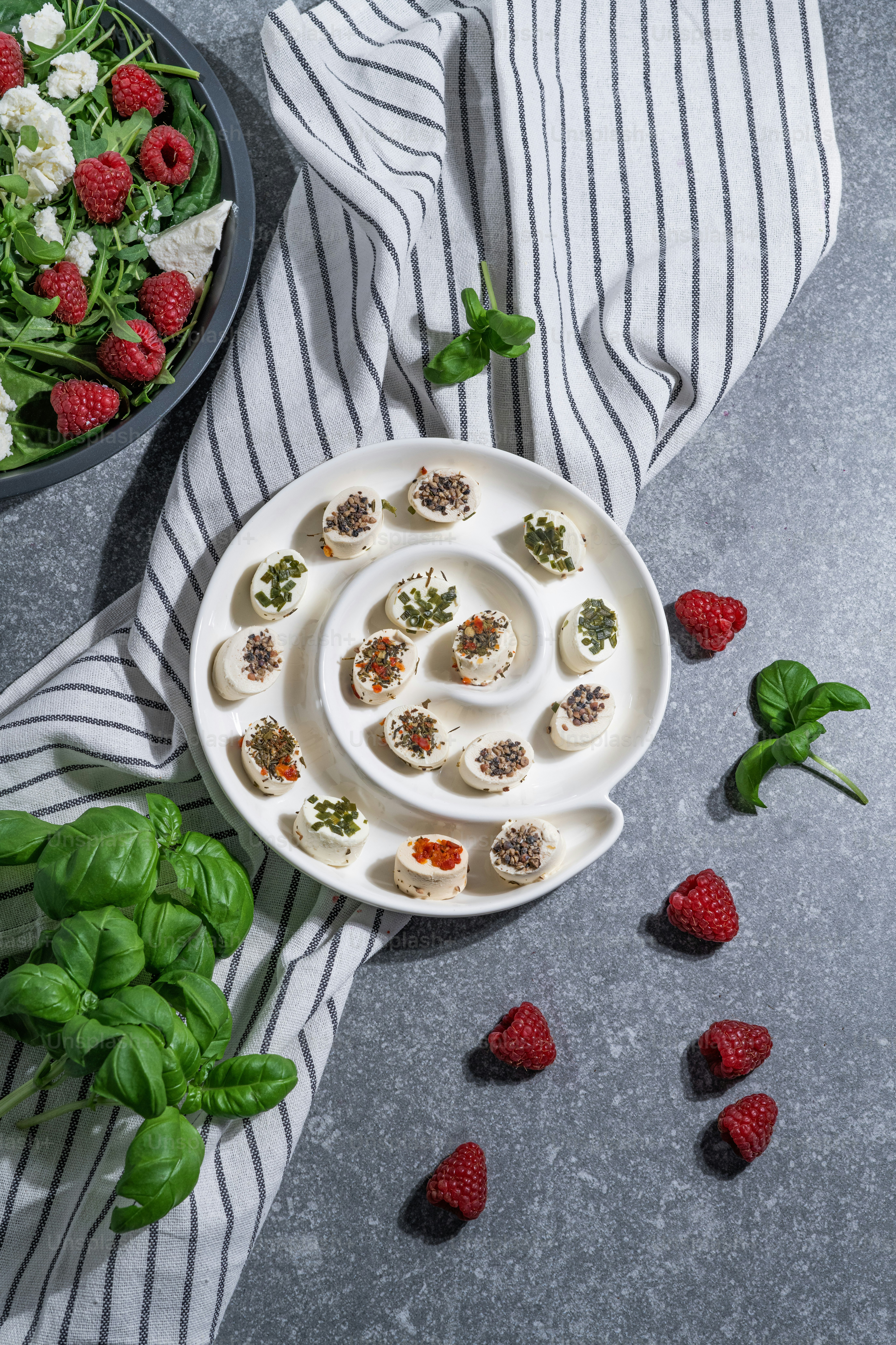 a plate of appetizers and a bowl of strawberries