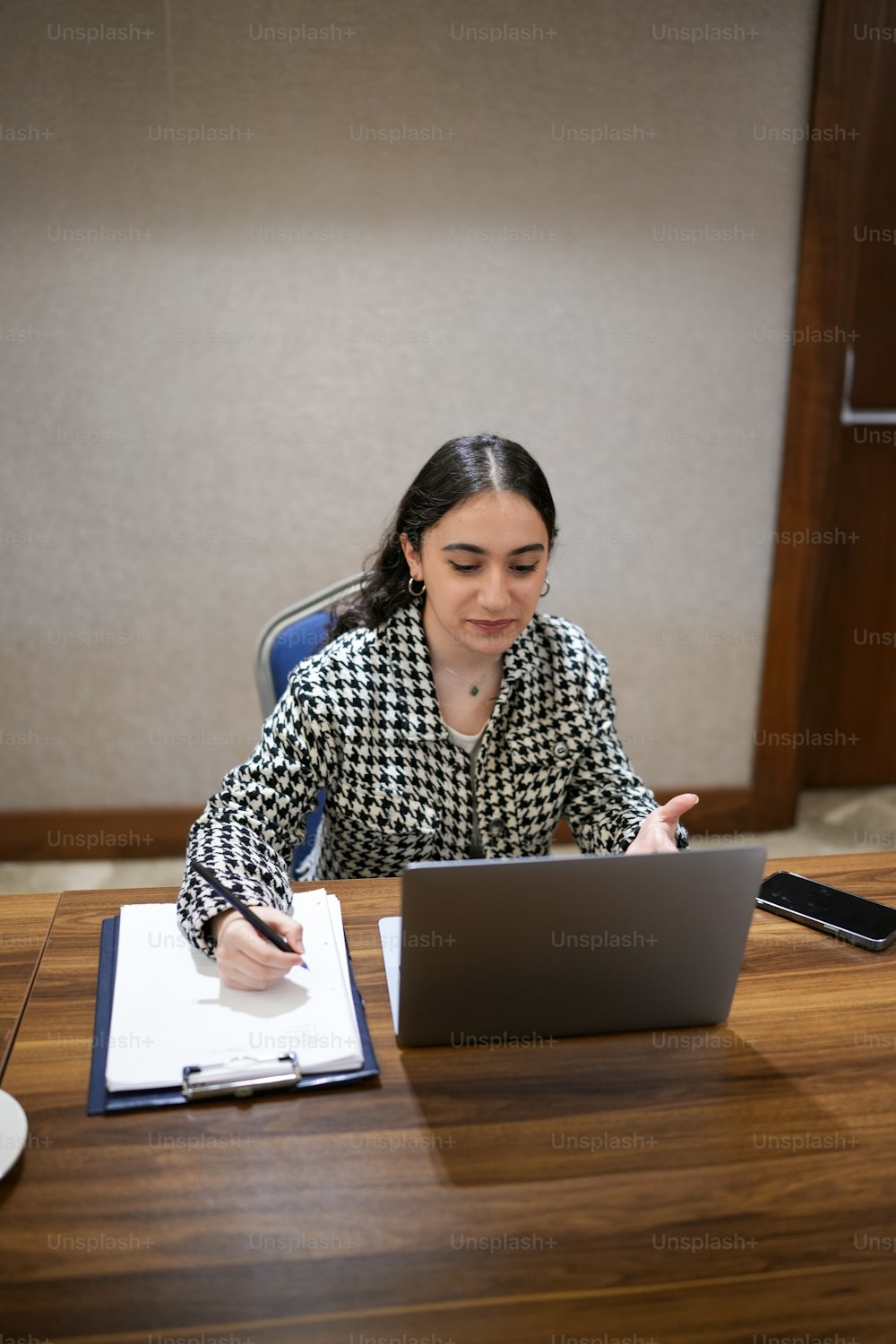 a woman sitting at a desk with a laptop