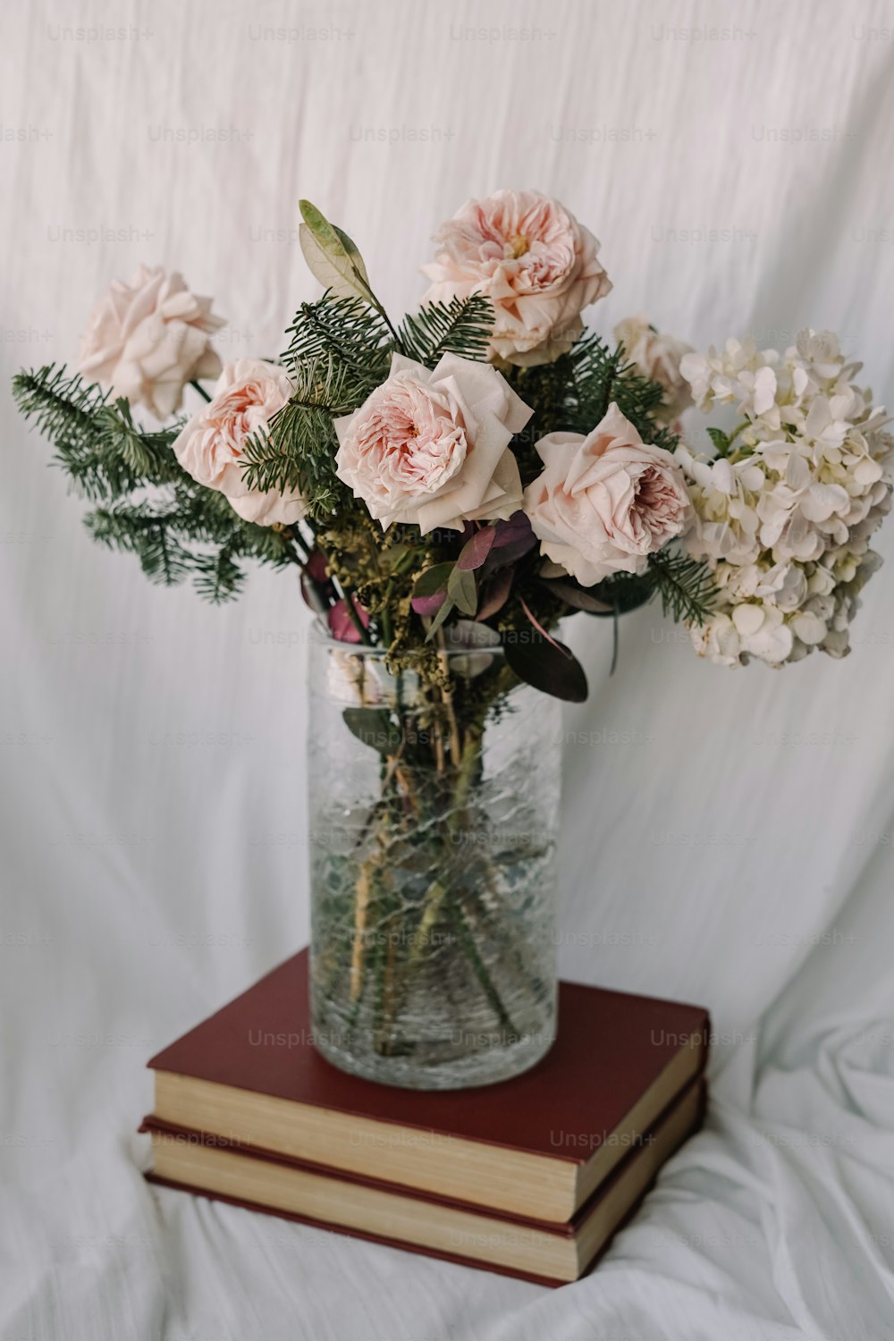 eine Vase mit Blumen auf einem Buch