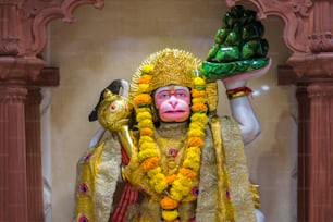 a statue of a monkey with a bird on his shoulder