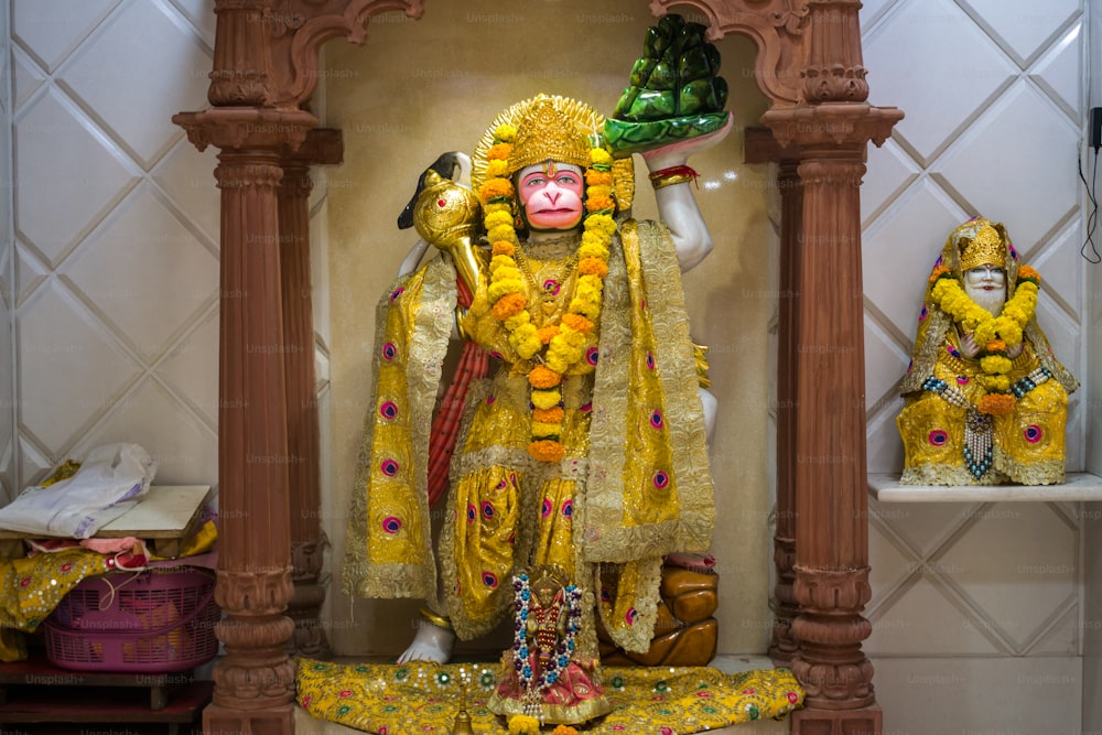 a statue of a monkey dressed in a yellow outfit