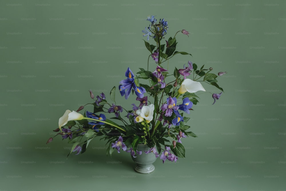 a vase filled with lots of purple and white flowers