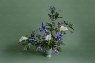 a vase filled with lots of purple and white flowers