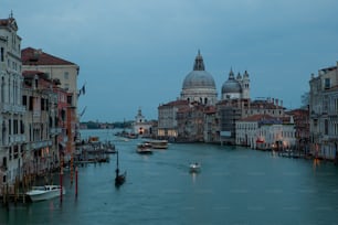 a waterway with boats and buildings in the background