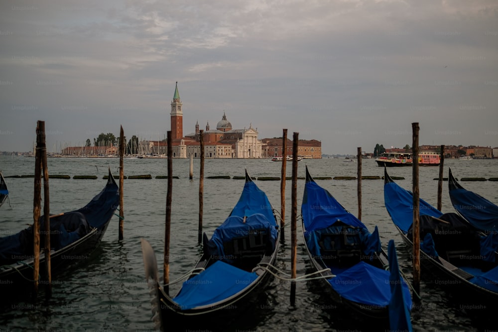 a row of gondolas sitting on top of a body of water