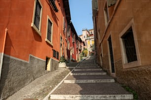 a narrow cobblestone street lined with buildings