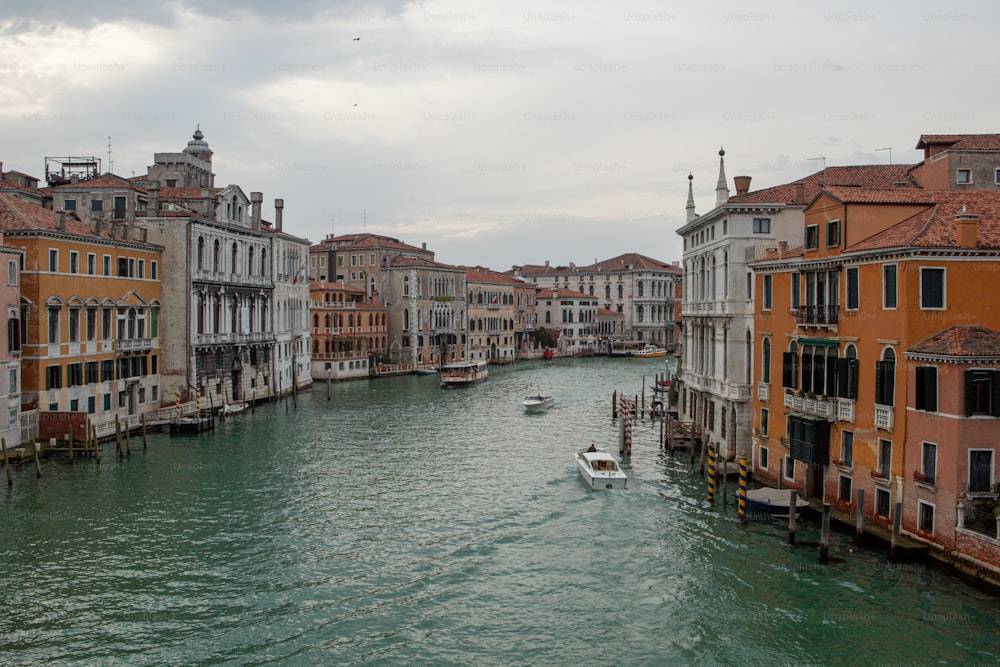 a boat traveling down a river next to tall buildings