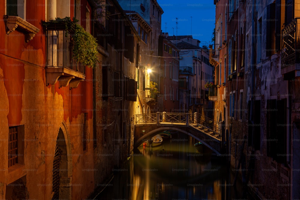 a narrow canal in a city at night