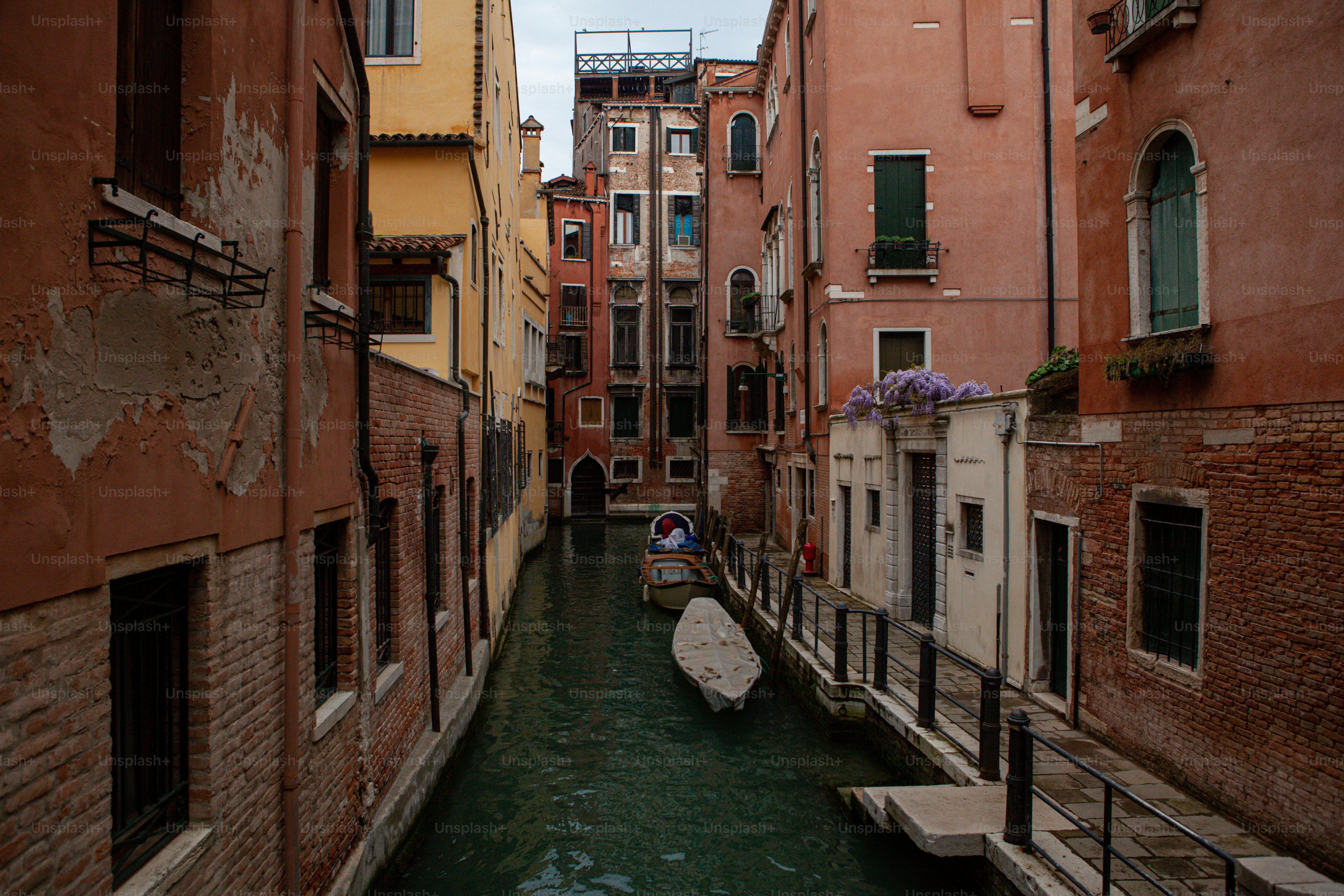 a narrow canal with a boat in the middle of it
