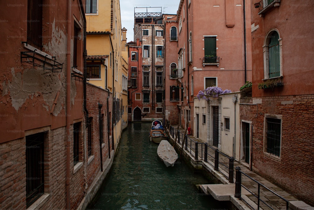 a narrow canal with a boat in the middle of it