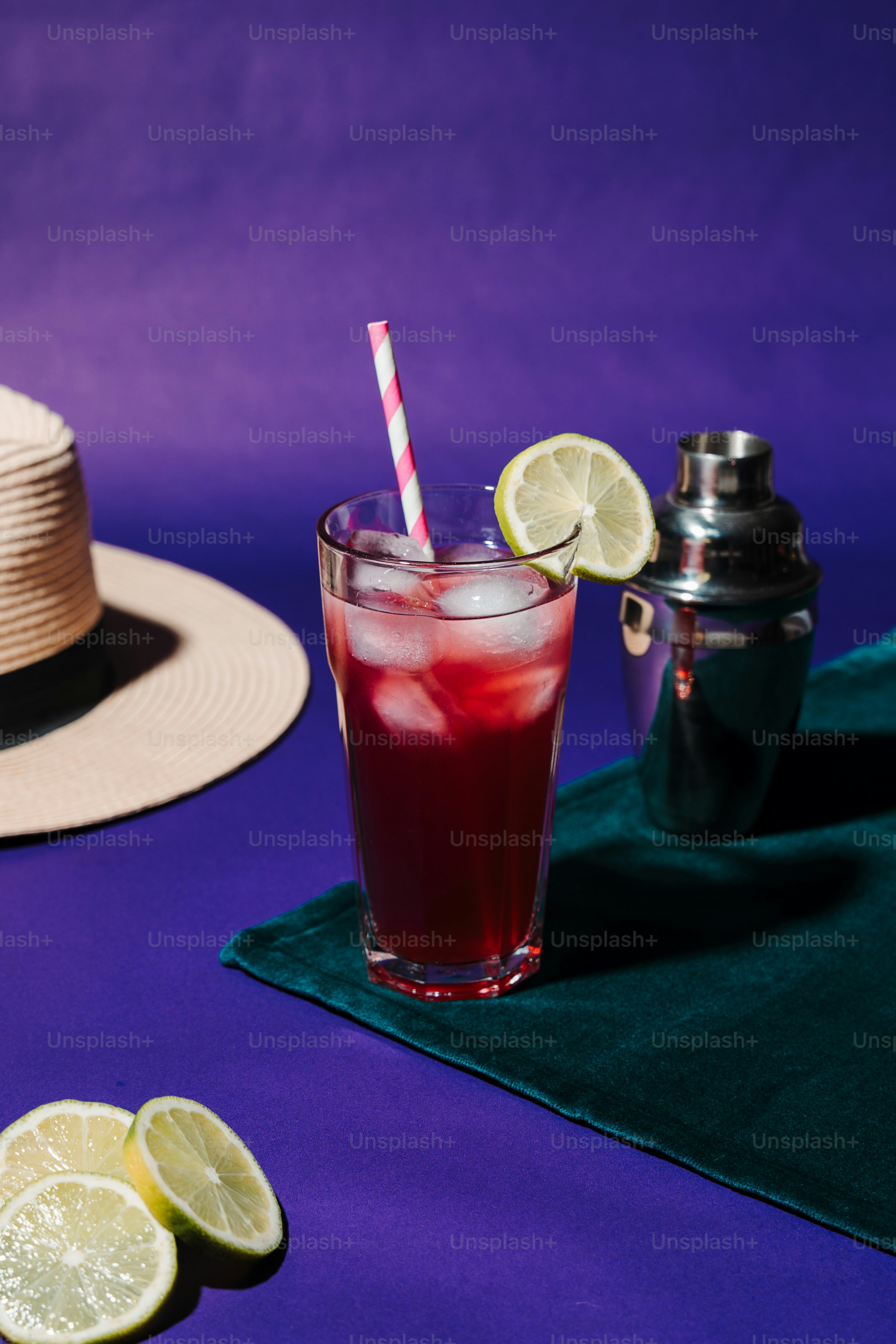 A drink with a straw and a straw hat next to it photo – Hard light ...