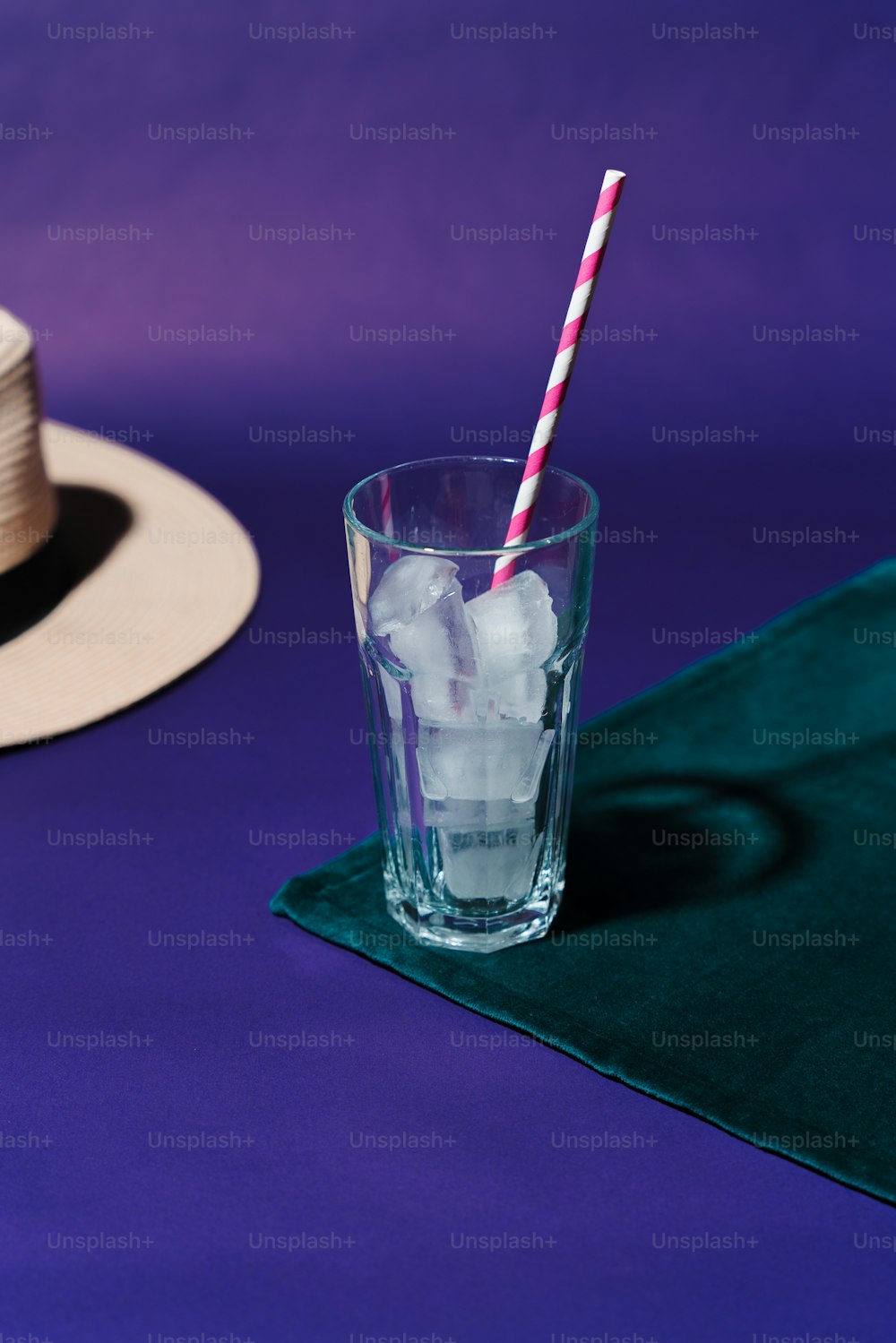 a glass filled with ice and a straw