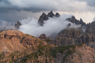 a mountain range covered in clouds and fog