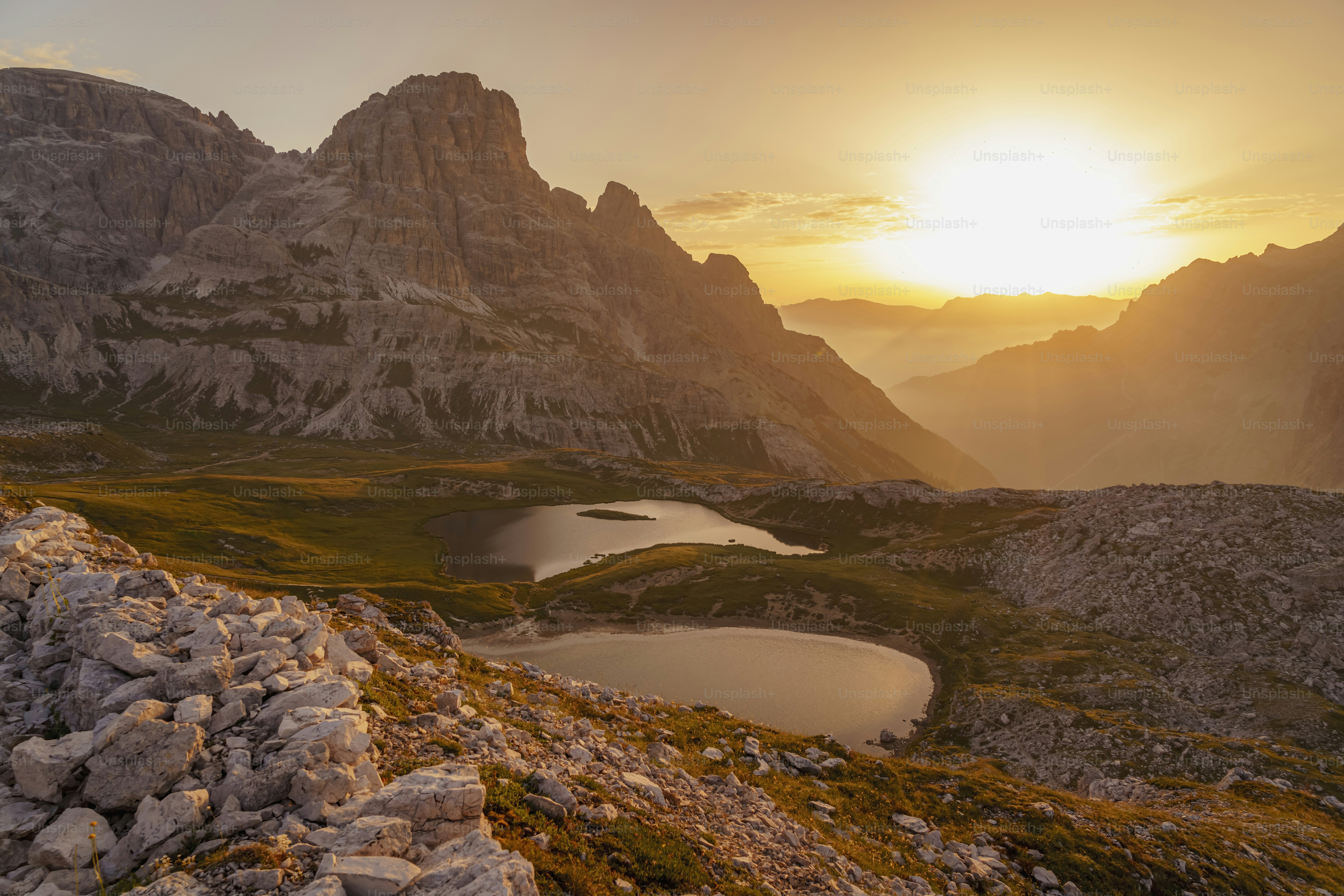 the sun is setting over a mountain range