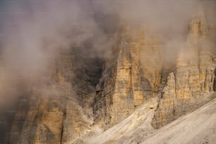 a group of mountains covered in fog and clouds