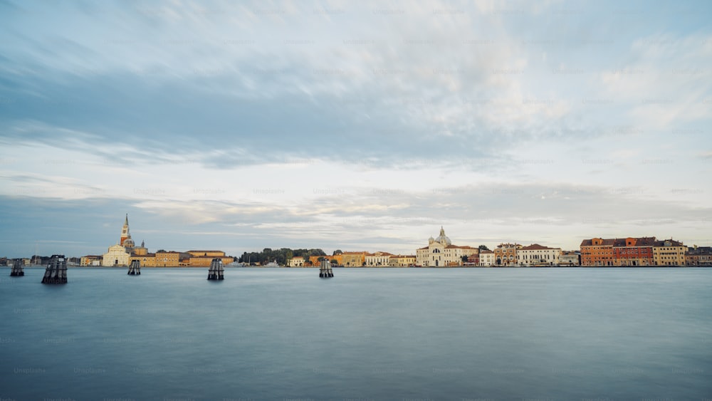 a large body of water with buildings in the background