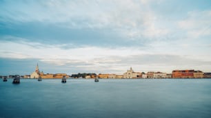 a large body of water with buildings in the background