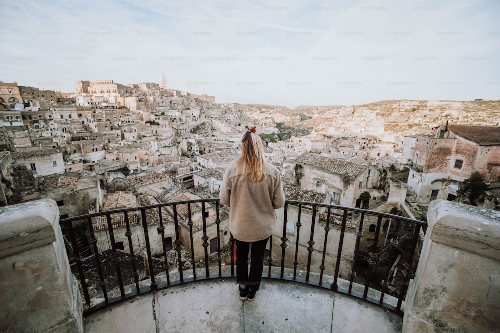 a woman standing on top of a metal railing