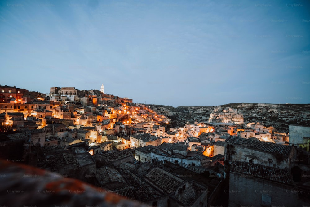 a view of a city at night from the top of a hill