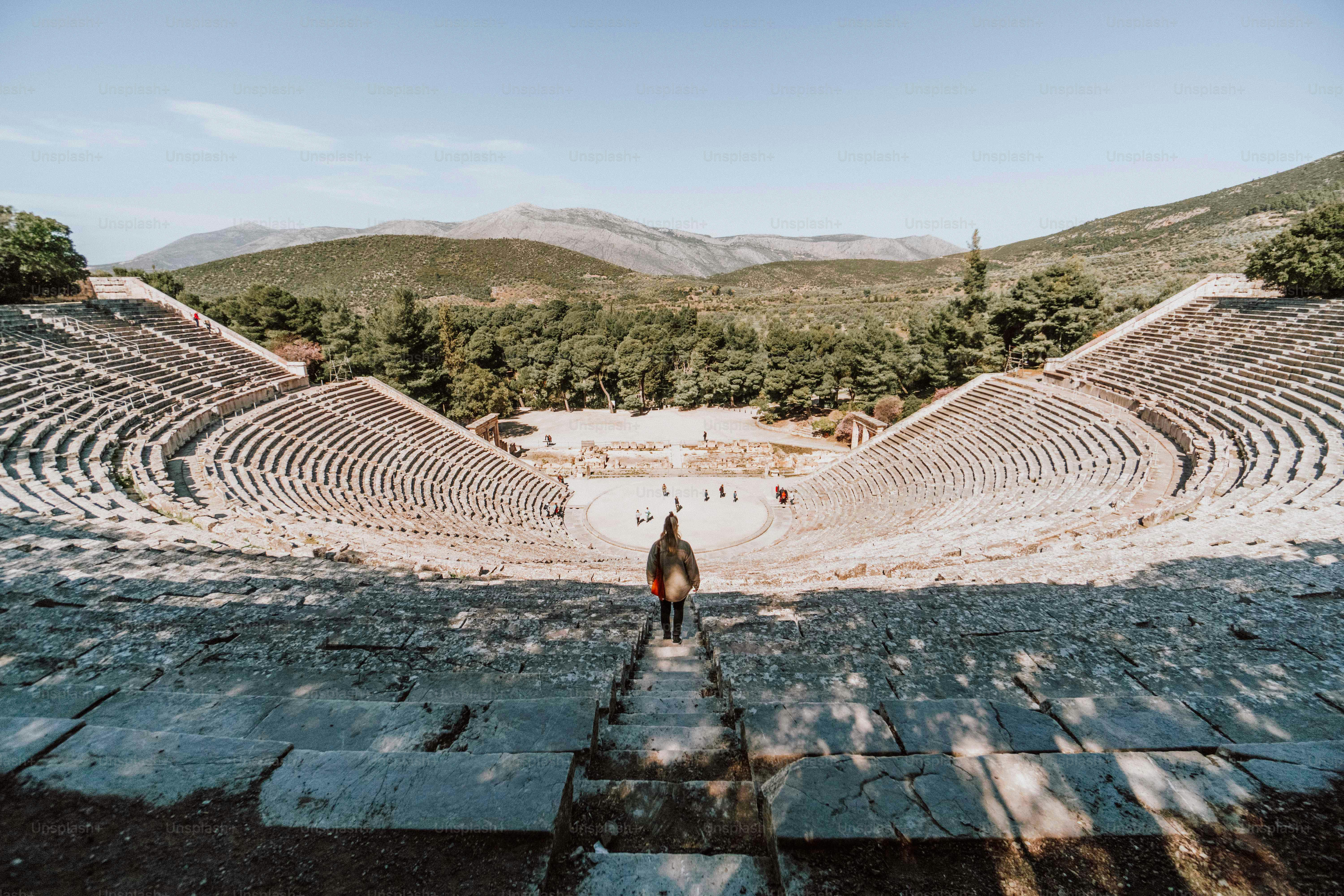 a man standing in front of a stone ampule