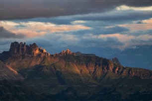 a mountain range with a few clouds in the sky