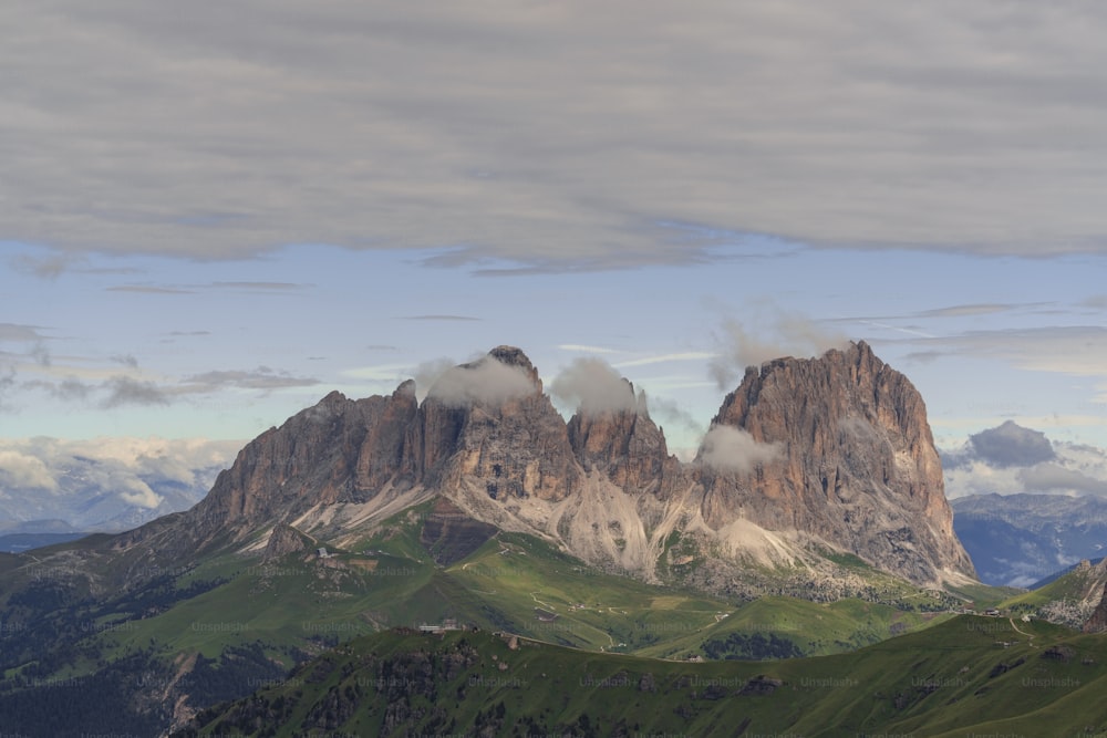 a mountain range with a few clouds in the sky