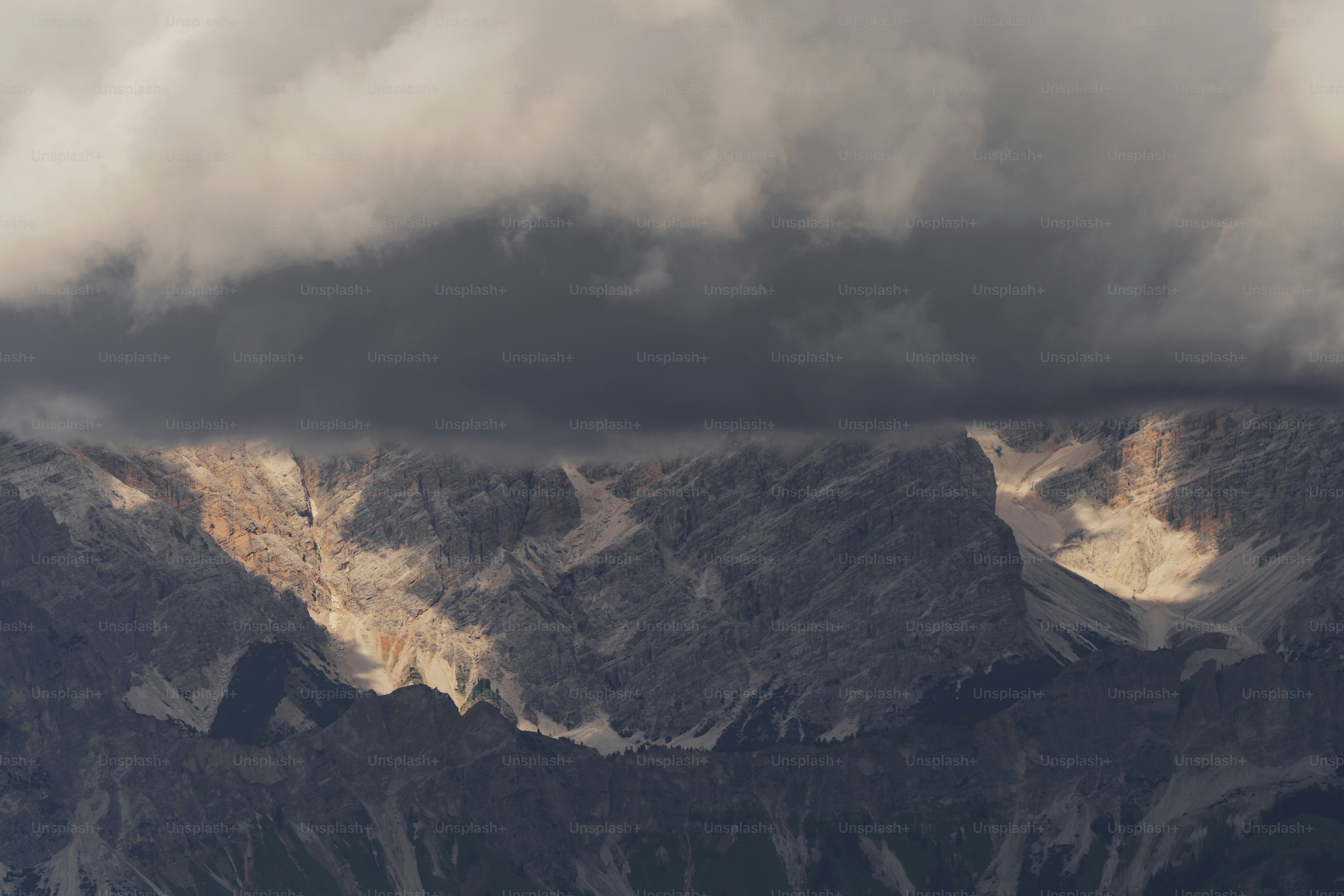 a view of a mountain range under a cloudy sky