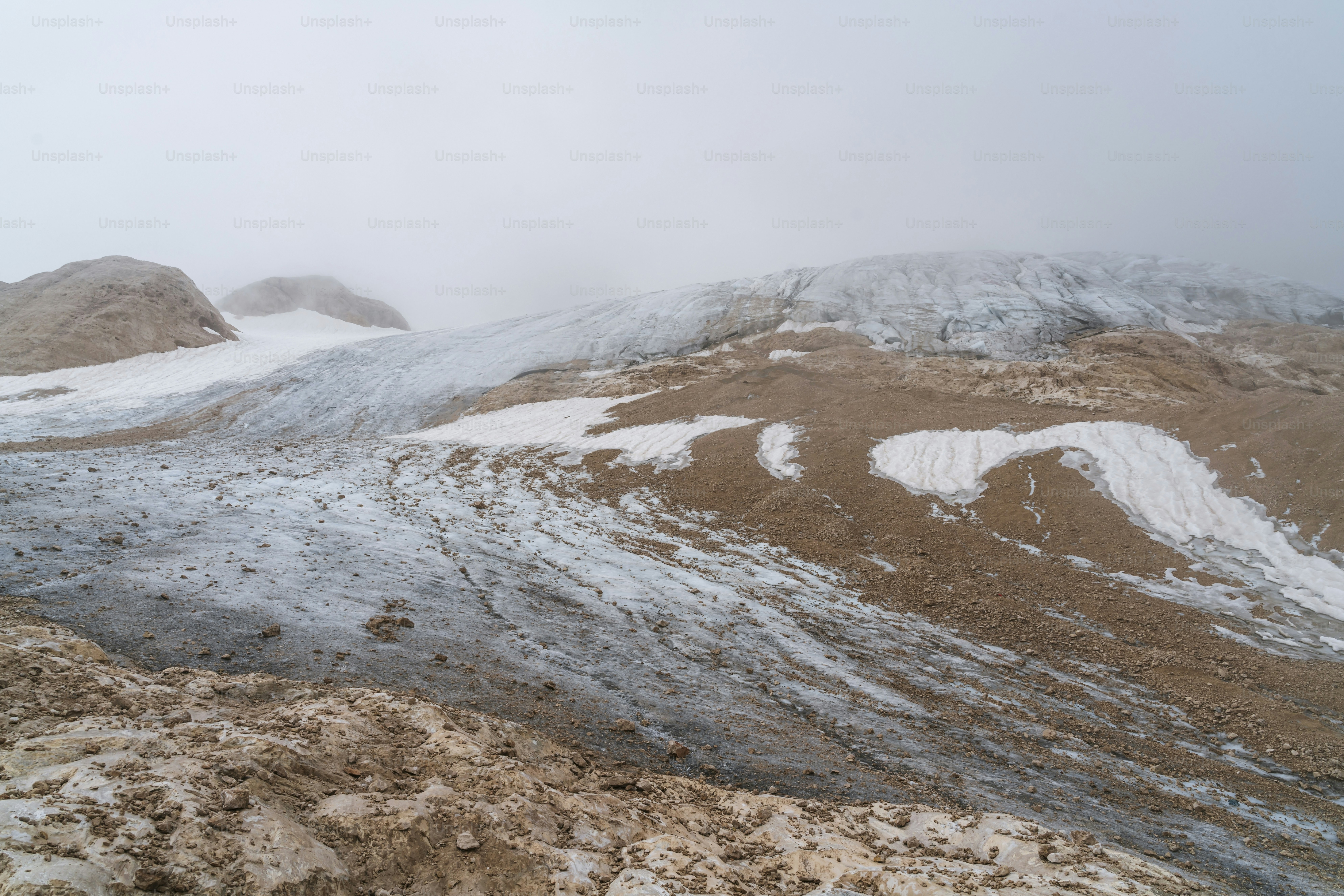 a mountain covered in snow on a cloudy day
