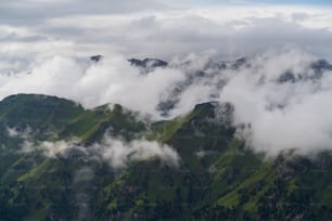 a view of a mountain range covered in clouds